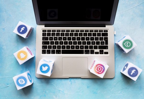 social-media-icon-blocks-laptop-blue-background